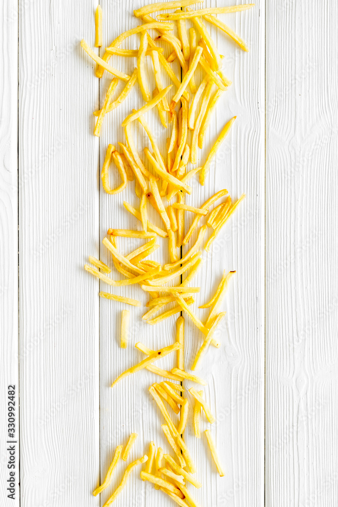 French fries background on white table top-down copy space