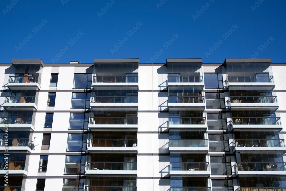 Modern apartment buildings on a sunny day with a blue sky. Facade of a modern apartment building