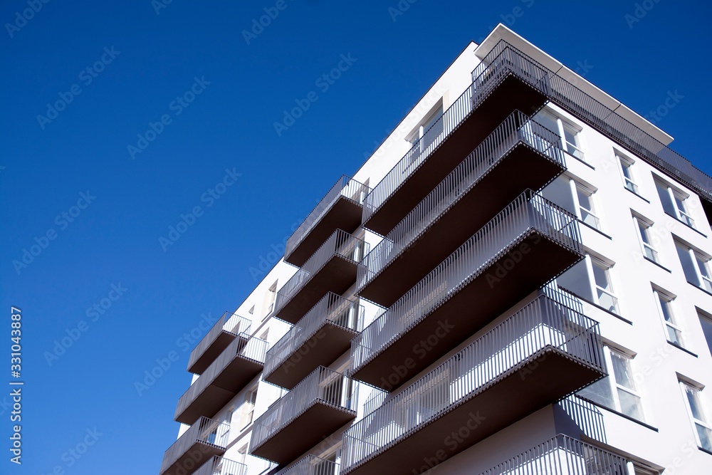 Modern apartment buildings on a sunny day with a blue sky. Facade of a modern apartment building