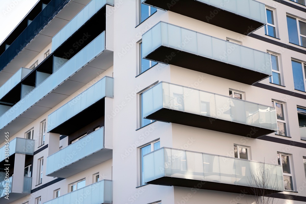 Modern apartment buildings on a sunny day with a blue sky. Facade of a modern apartment building