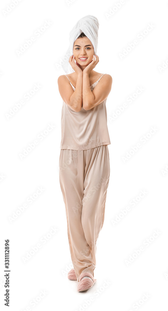 Portrait of woman in pajamas and with towel on white background