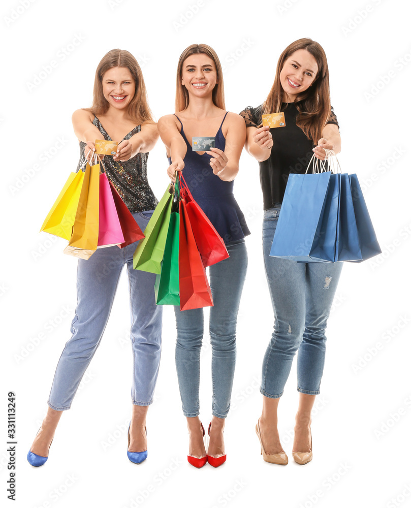 Young women with shopping bags on white background