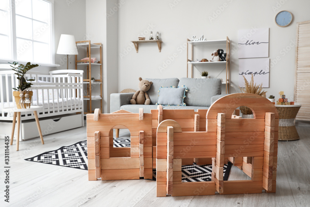 Wooden take-apart playhouse in interior of childrens room