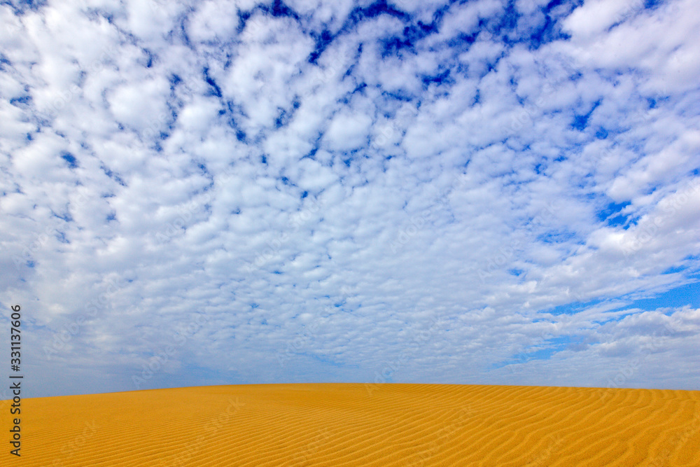 Summer dry landscape in Africa. Black pebble stones. Sandy waves in the wild nature. Dunas Maspaloma