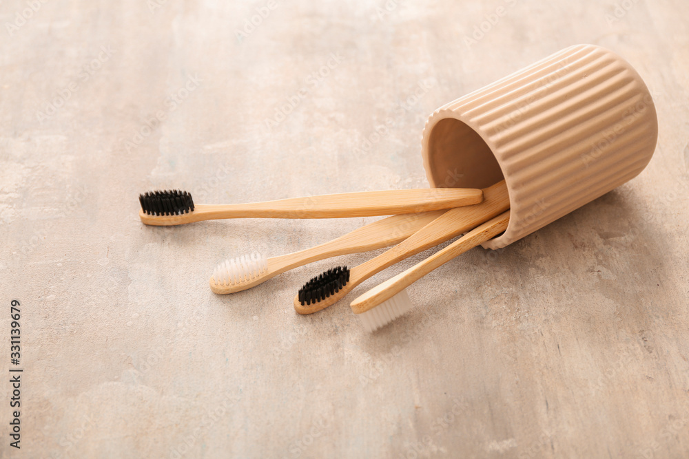 Holder with tooth brushes on light background