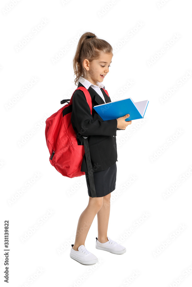 Cute little schoolgirl with book on white background