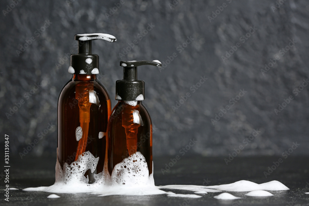 Shampoo and foam on dark background