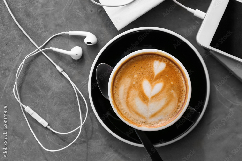 Cup of tasty cappuccino on grey table