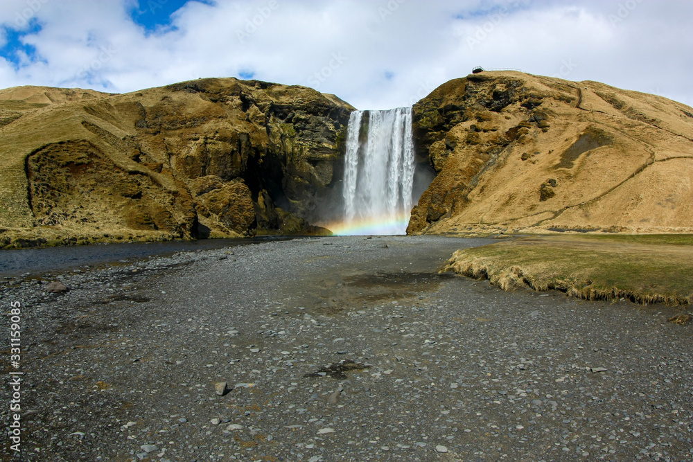 Beautiful high waterfall with a rainbow in Iceland