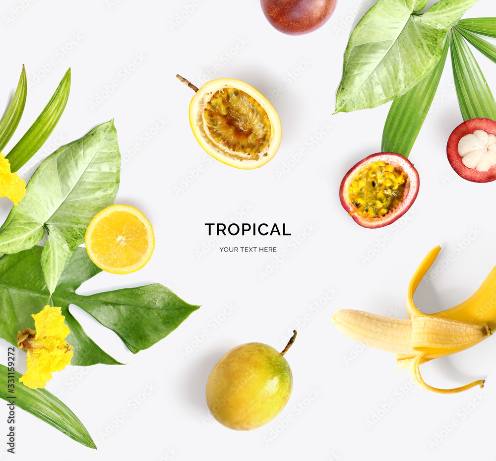 Creative layout made of mangosteen, banana, passion fruit, lemon and tropical leaves and flowers on 