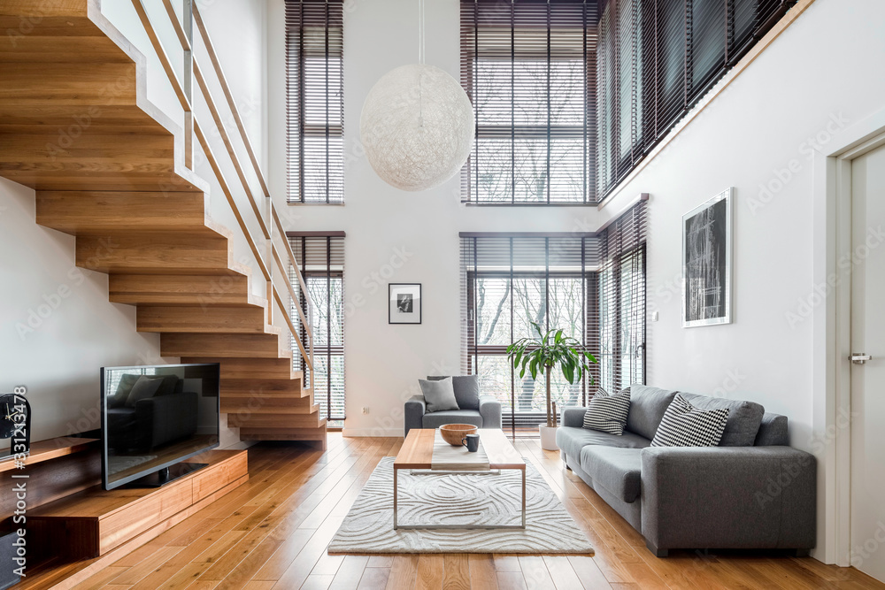 Spacious living room with wooden stairs