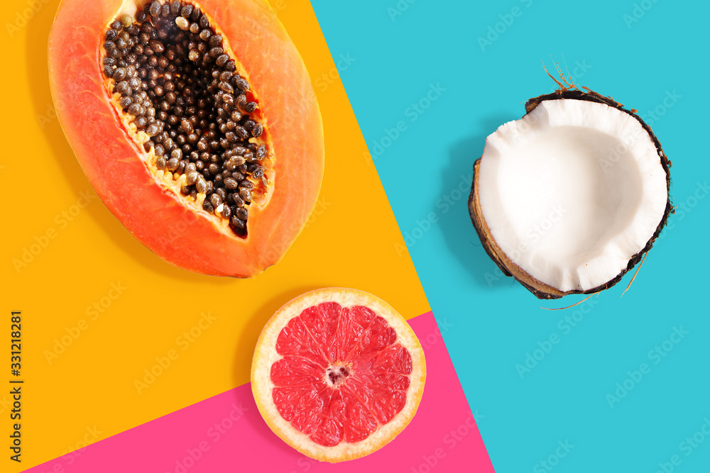 Creative layout made of papaya, grapefruit, coconut on the bright background. Flat lay. Food concept