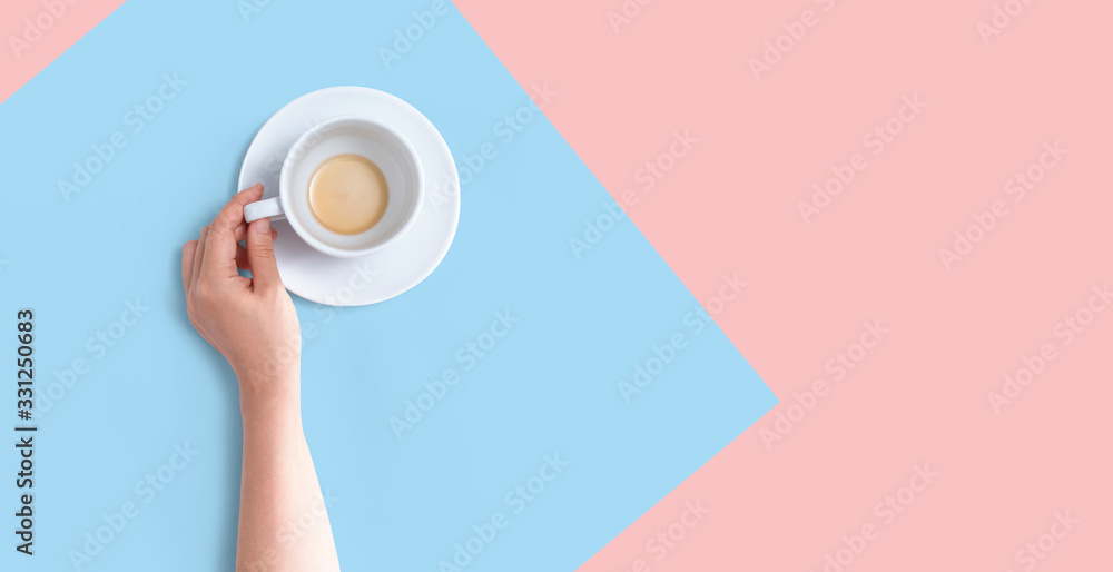 Female hand holding a tea cup overhead view - flat lay