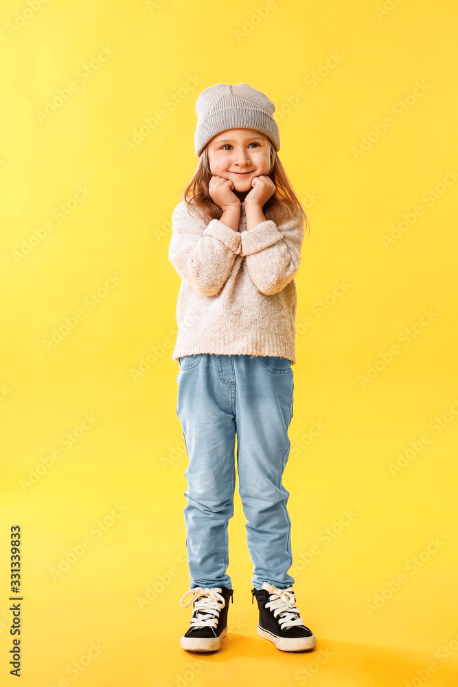 Cute little girl on color background