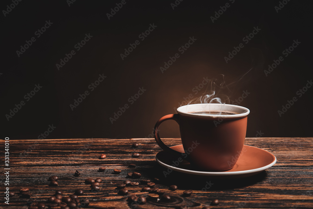 Cup of hot coffee on wooden table