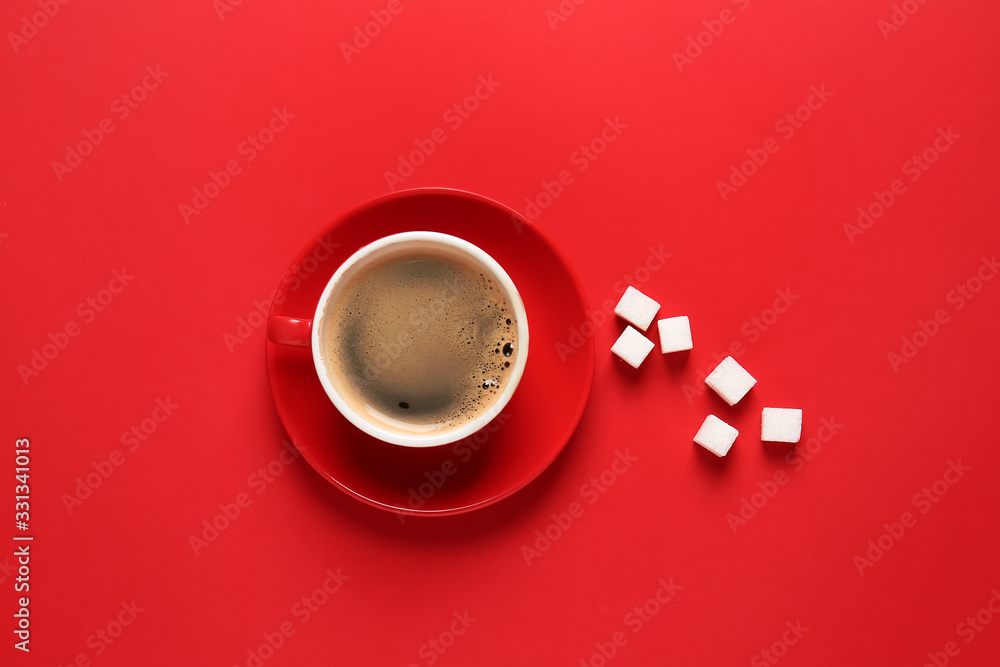 Cup of hot coffee and sugar on color background