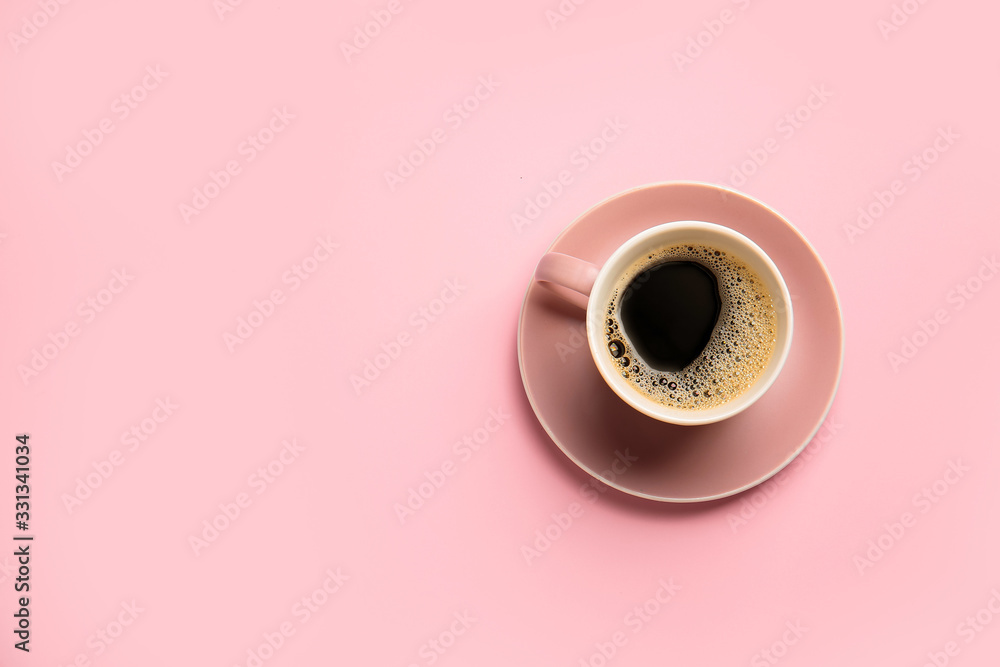 Cup of hot coffee on color background