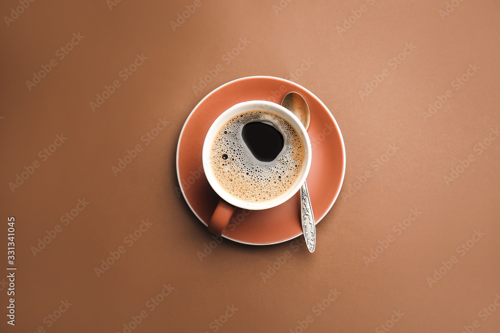 Cup of hot coffee on color background