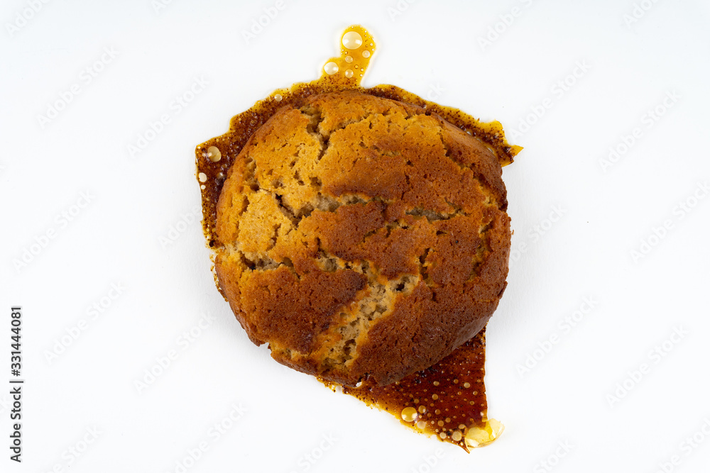 A cookie cake with peanut butter and caramel on white background with copy space - top view