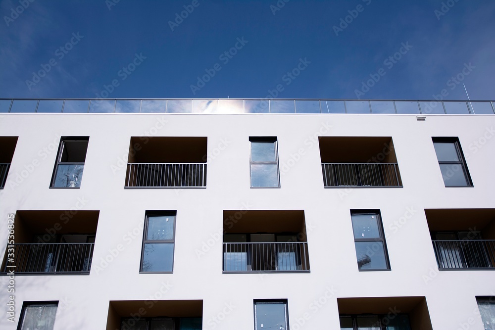 Exterior of new apartment buildings on a blue cloudy sky background. No people. Real estate business