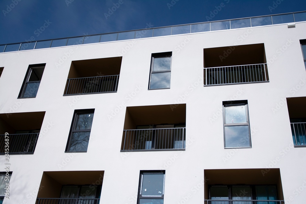 Exterior of new apartment buildings on a blue cloudy sky background. No people. Real estate business