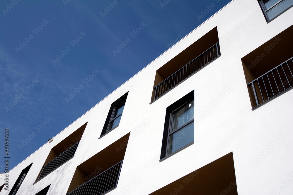 Exterior of new apartment buildings on a blue cloudy sky background. No people. Real estate business