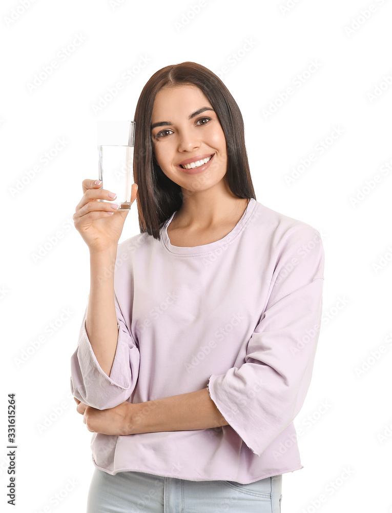 Beautiful young woman with glass of water on white background