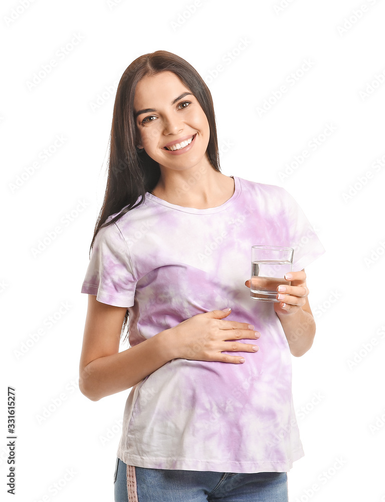 Beautiful pregnant woman with glass of water on white background