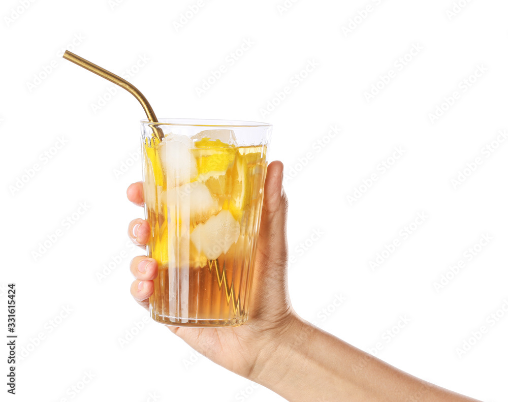 Female hand with cold tea in glass on white background