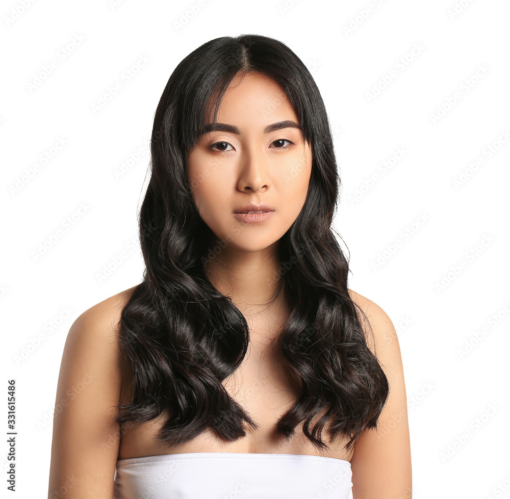 Young Asian woman with beautiful long hair on white background