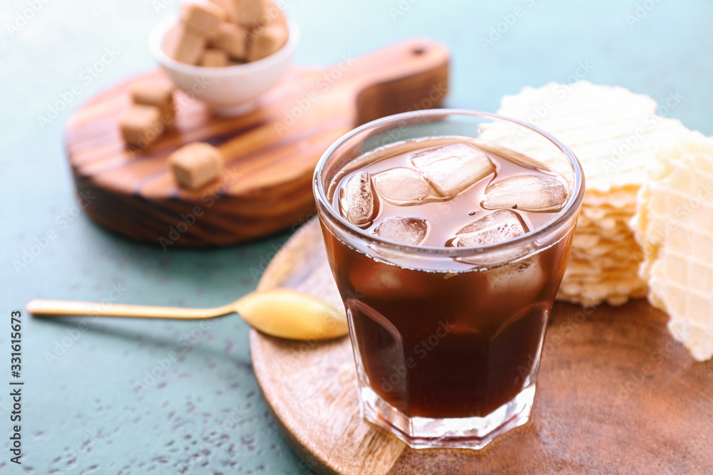 Glass of tasty iced coffee on table