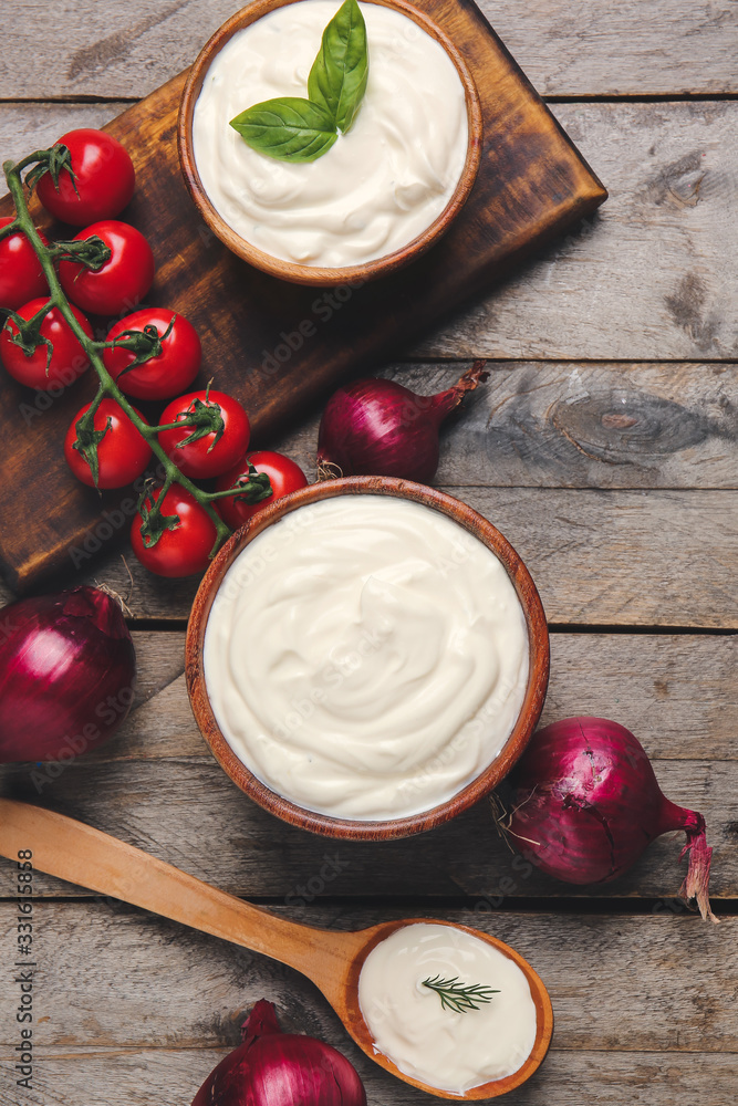 Composition with tasty sour cream on table