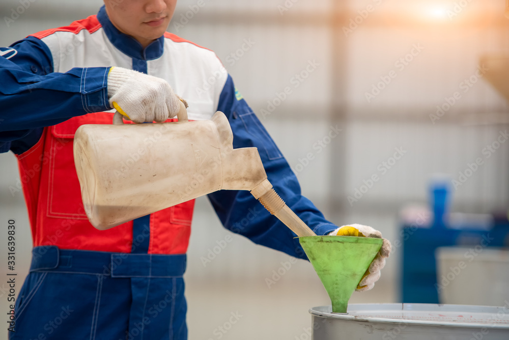 Mechanic and engine oil,Hand mechanic in repairing car,Change the Oil.