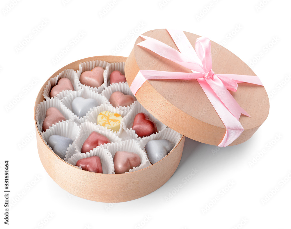 Box with delicious candies on white background