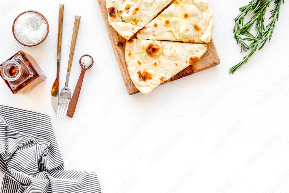 Italian focaccia with cheese and rosemary on white background top-down copy space