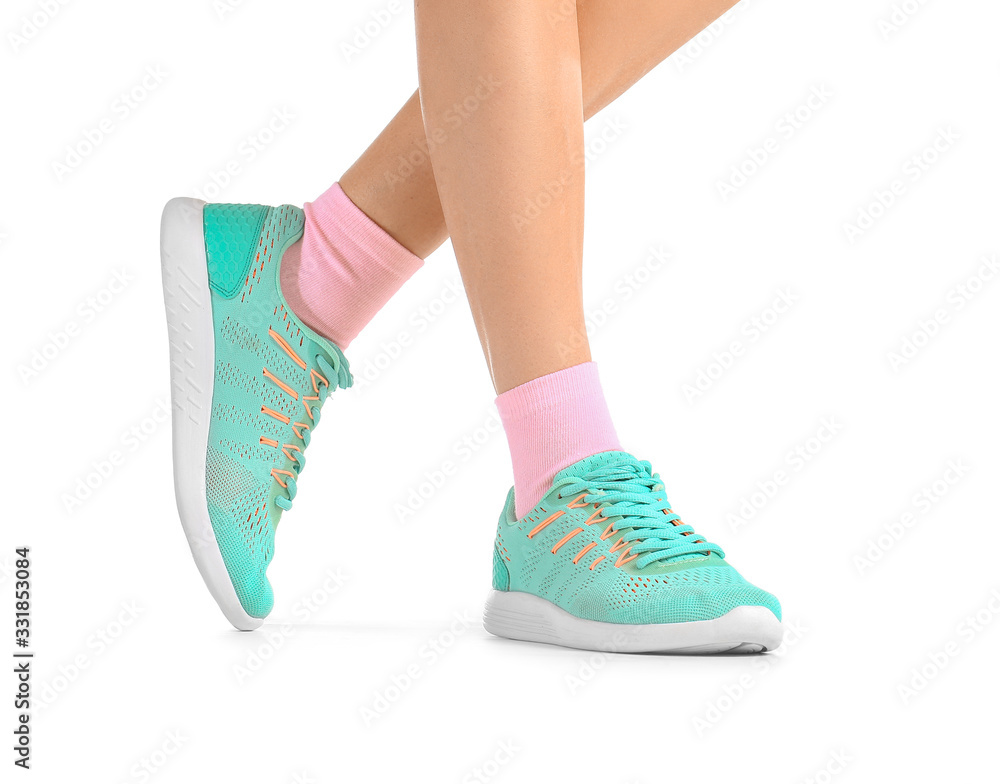 Legs of young woman in socks and shoes on white background