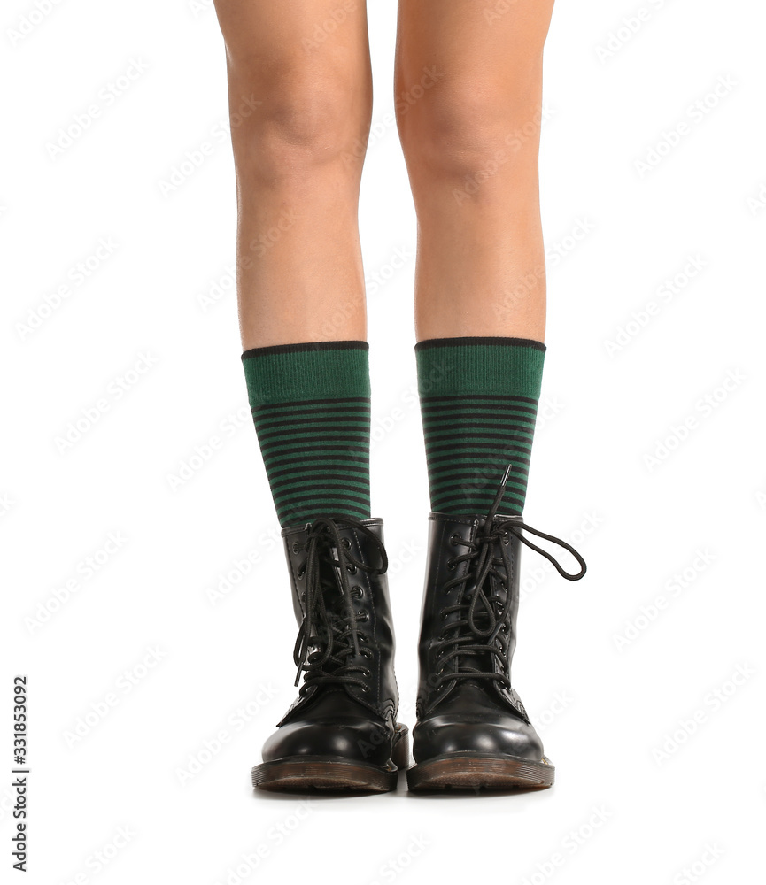 Legs of young woman in socks and shoes on white background