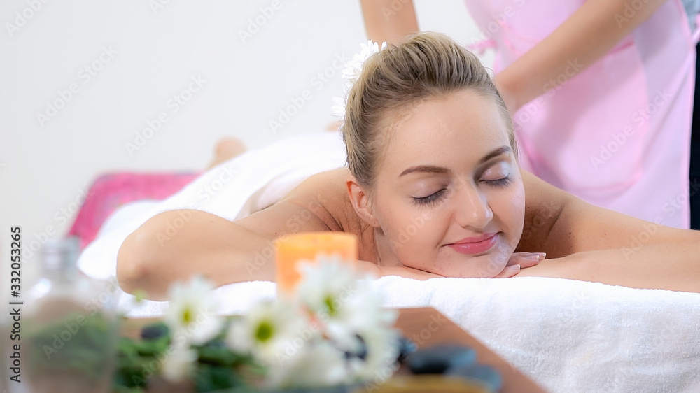 Woman gets back massage spa by massage therapist.