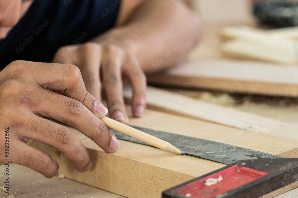 Carpenter working on wood craft at workshop