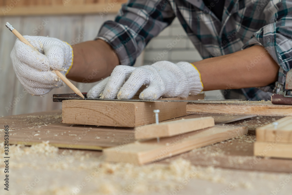 Carpenter working on wood craft at workshop