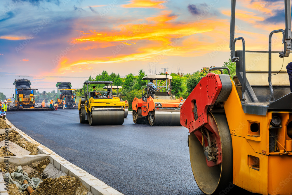 Construction site is laying new asphalt road pavement,road construction workers and road constructio