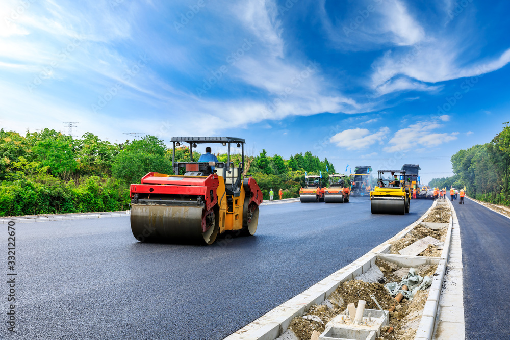 Construction site is laying new asphalt road pavement,road construction workers and road constructio