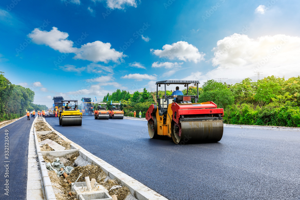 Construction site is laying new asphalt road pavement,road construction workers and road constructio