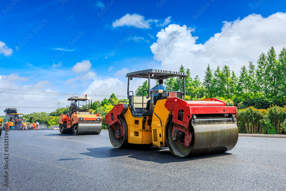 Construction site is laying new asphalt road pavement,road construction workers and road constructio