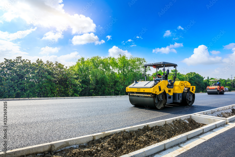 Construction site is laying new asphalt road pavement,road construction workers and road constructio