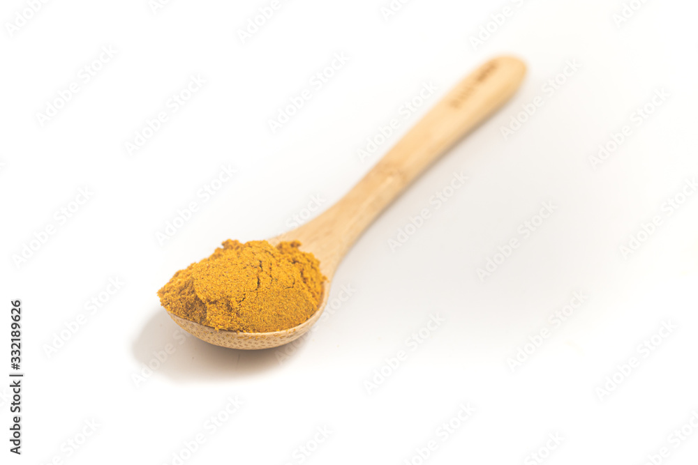 Curry Powder into a teaspoon. Measuring spoon