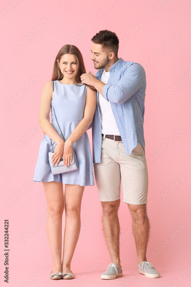 Happy young couple on color background