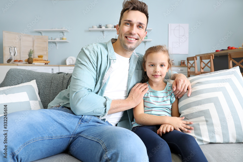 Young father with daughter having video call at home