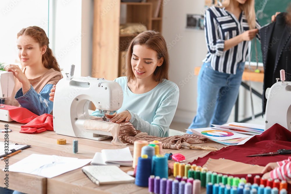 Young women during tailors class in atelier