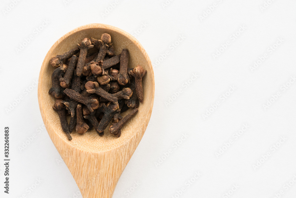 Whole Cloves on a Wood Spoon